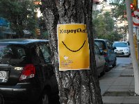 Poster on tree: Smile! It's the second best thing you can do with your lips.