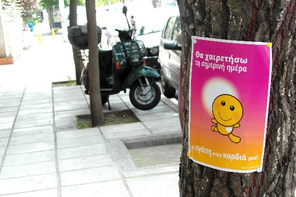 Poster on tree: I will greet this day with love in my heart