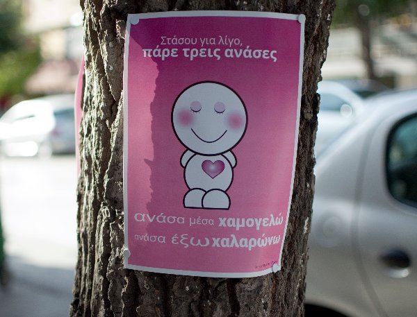 Poster on tree: Breath In, Smile :) Breath Out, Relax...