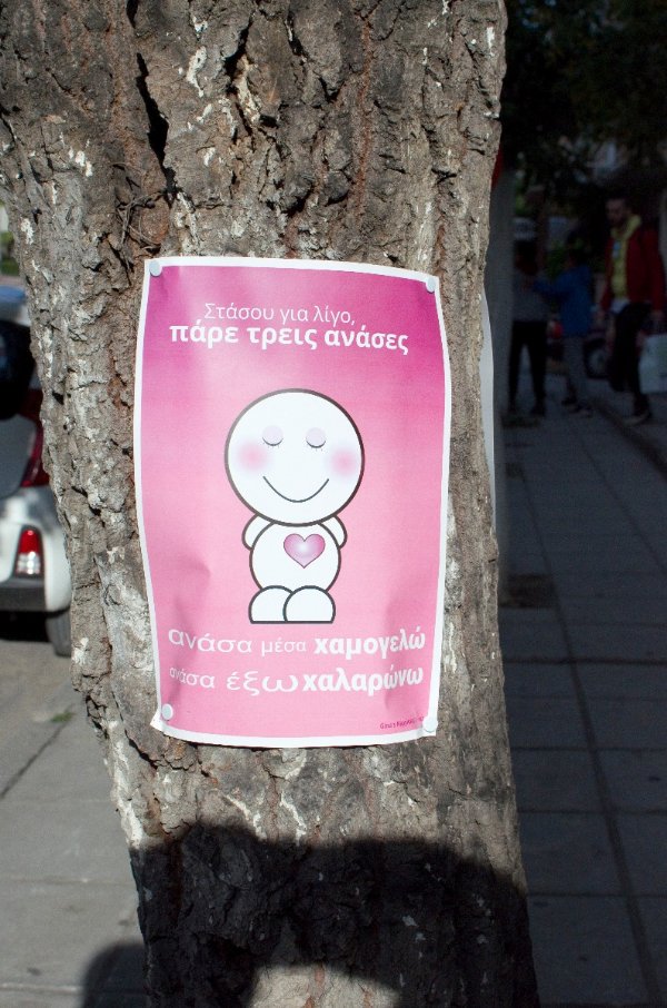 Poster on tree: Breath In, Smile :) Breath Out, Relax...